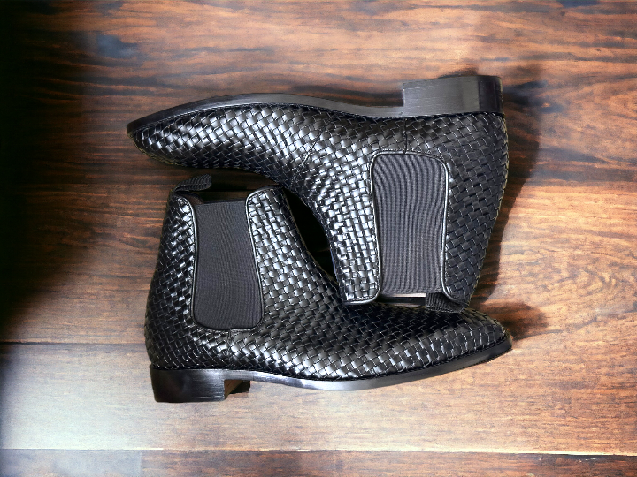 Expertly crafted and stylish, these black woven leather Chelsea boots are the perfect addition to any man's wardrobe. With a sleek and fashionable design, these boots will elevate any outfit while providing comfort and durability. Perfect for any dressy occasion, these handmade boots are a must-have for the modern man.