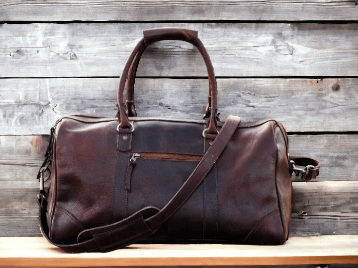 This premium sports duffle bag is made of full grain high quality genuine leather, ensuring durability and style. With its spacious interior and multiple compartments, it offers convenient storage for all your sports equipment. Perfect for athletes and fitness enthusiasts, this bag combines practicality with luxury.